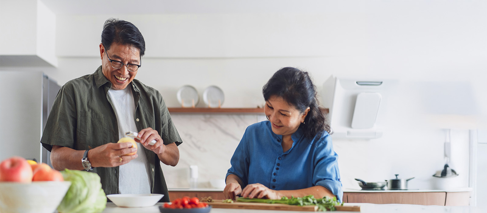 Mature Asian couple preparing meal
