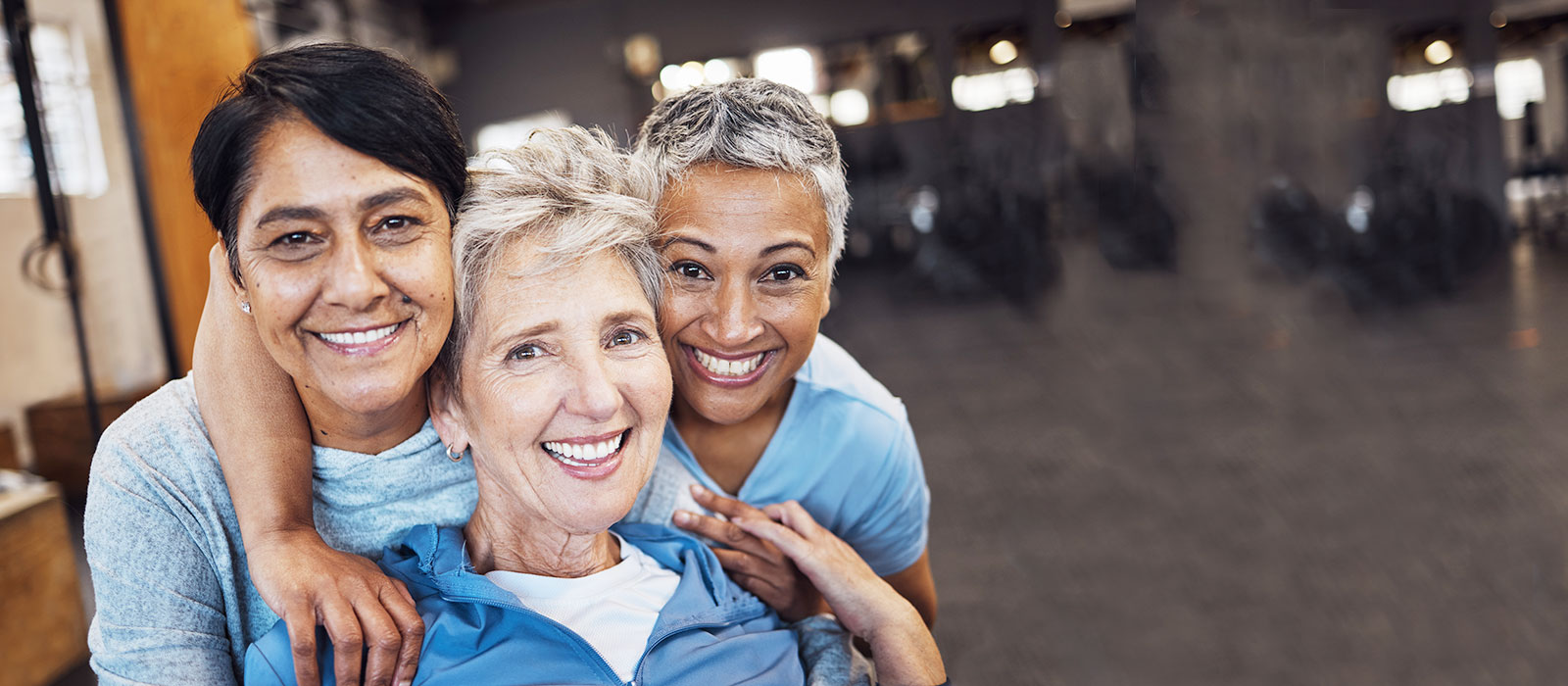 three mature female gym friends