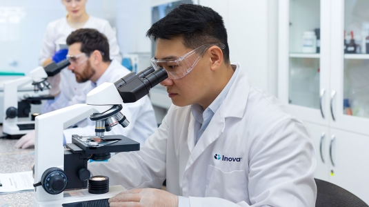 Scientist looking into a microscope