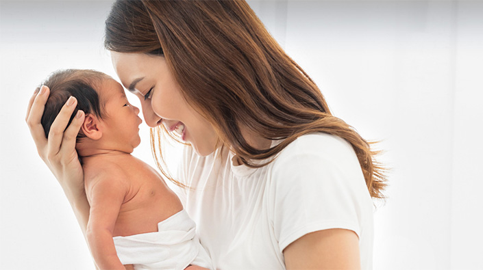 young mother holding newborn