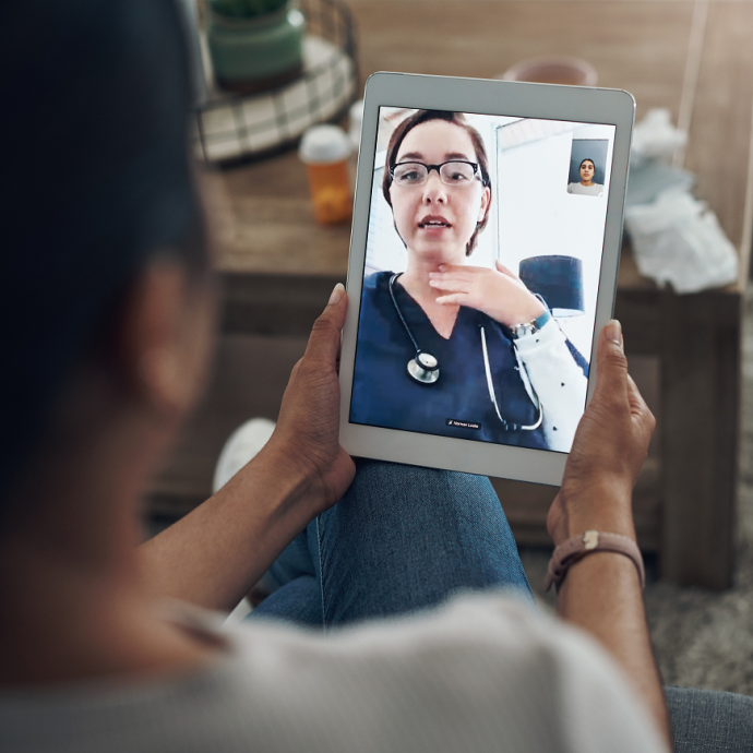 Closeup of a patient talking to a doctor on an ipad